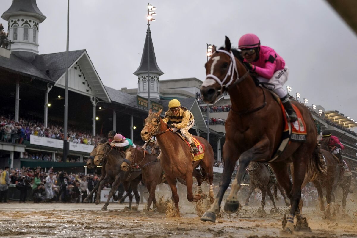 Country House, center, races to the finish line behind Maximum Security, right, during the 2019 Kentucky Derby.