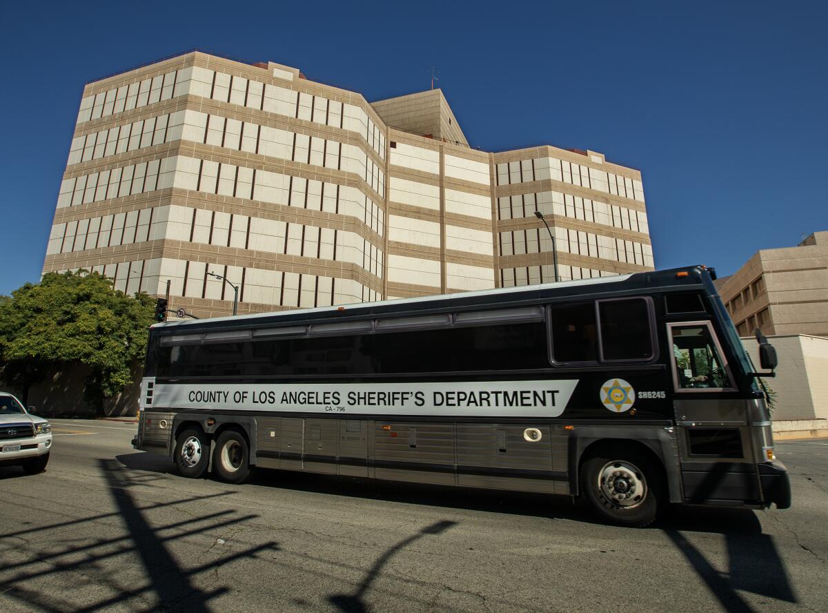 A Los Angeles County Sheriff's Department bus used to transport inmates drives past Twin Towers jail in downtown L.A.