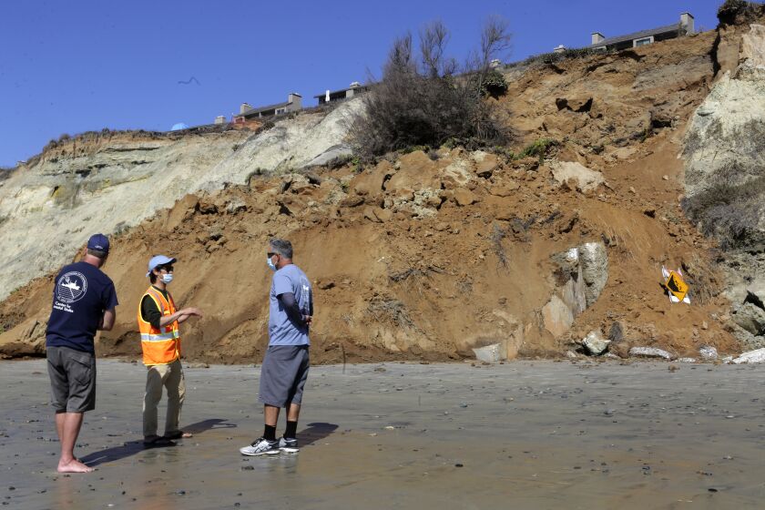 A crew from the Scripps Institution of Oceanography UC San Diego Center of Coastal Studies arrived Monday to gather data at a section of coastal bluff which collapsed in Del Mar sometime late Saturday night or early Sunday morning. Residences can be seen on the bluff top just south of 4th Street in Del Mar. photo by Bill Wechter