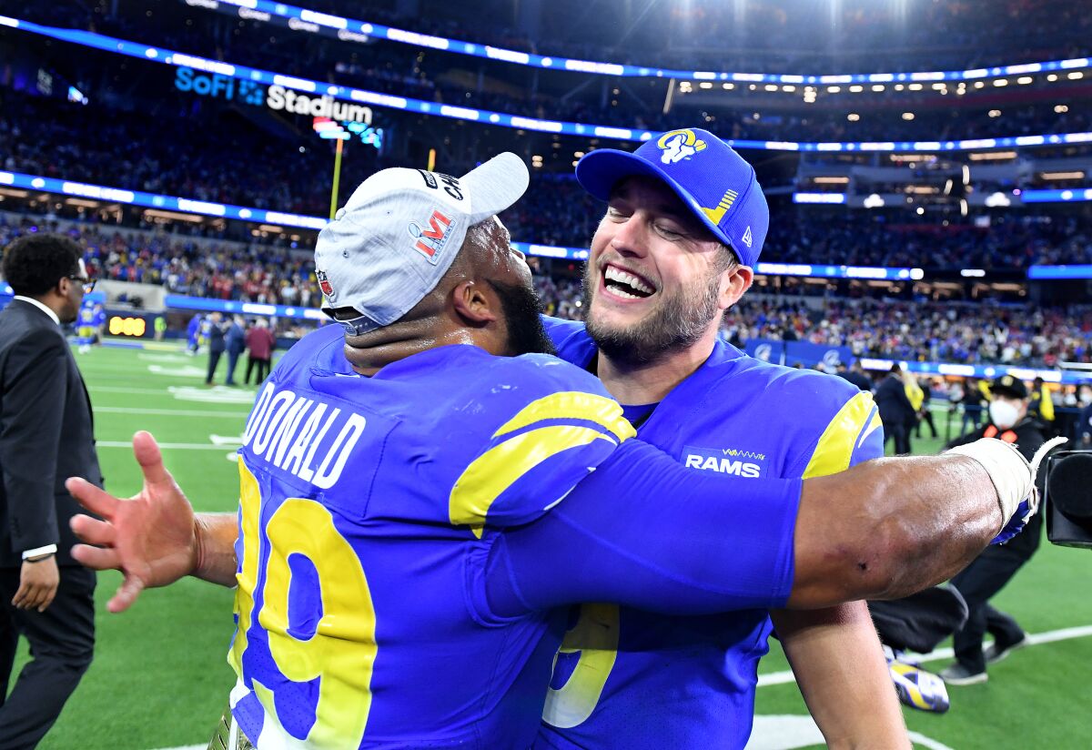 Rams defensive lineman Aaron Donald, left, celebrates with quarterback Matthew Stafford after beating the 49ers.