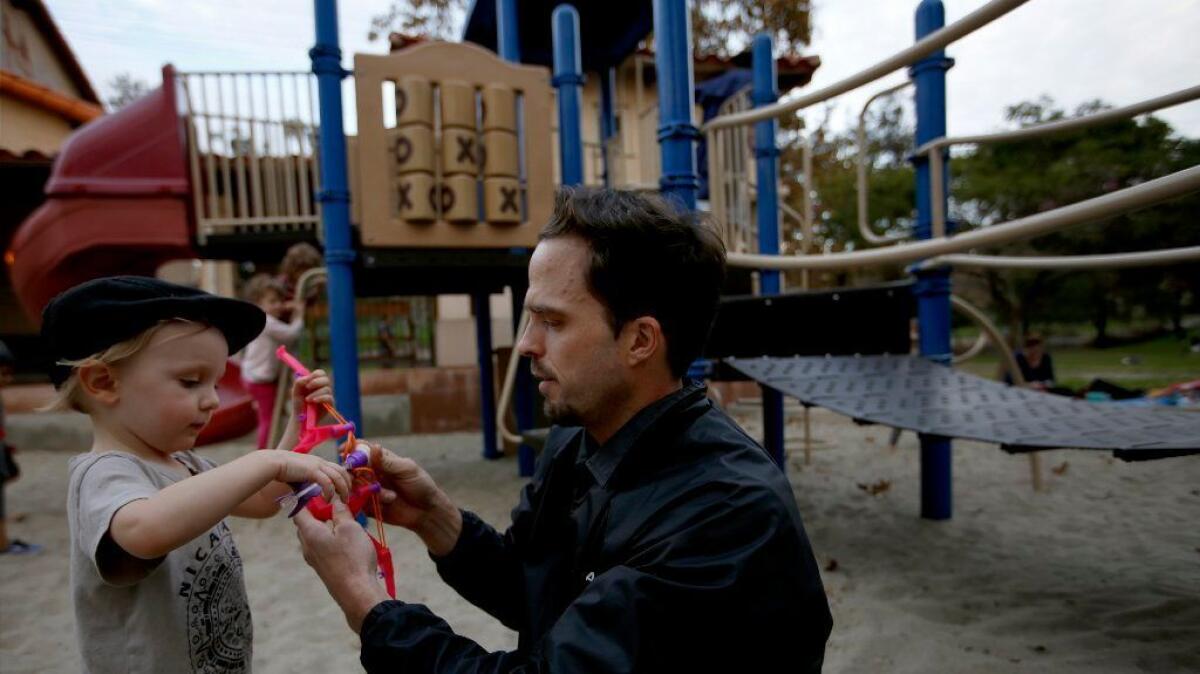 Primo Trunell, 2, plays with his father, Jeffrey Trunell, of Los Angeles, at a city playground in Silver Lake.