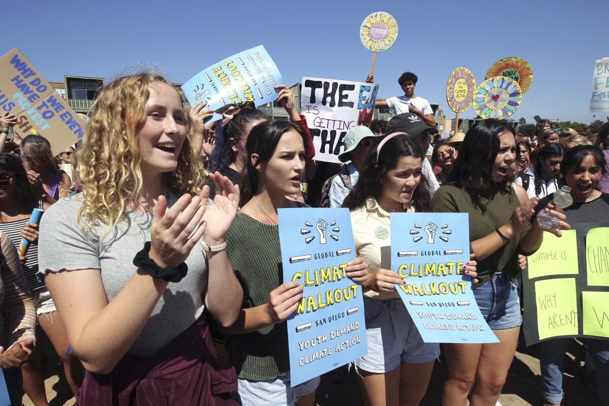 Hundreds of students across the San Diego area walked out of class Friday to urge action on climate change