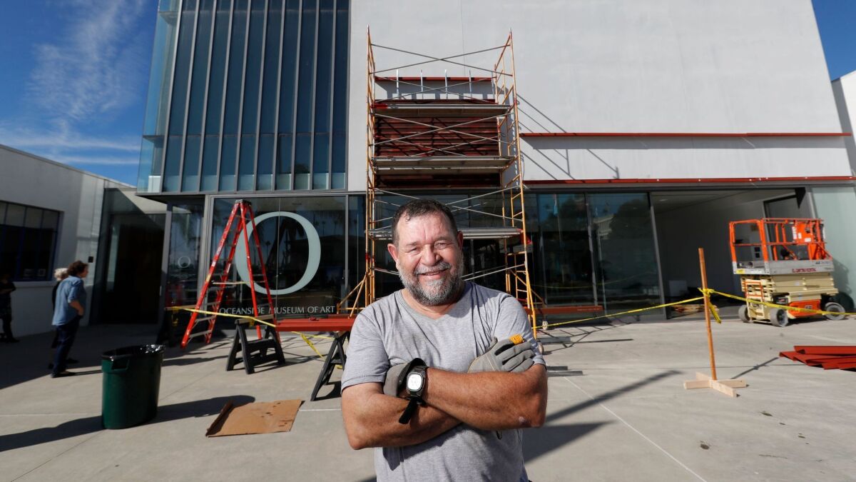 Marcos Ramirez ERRE installs "Of Fence" on the facade of the Oceanside Museum of Art.