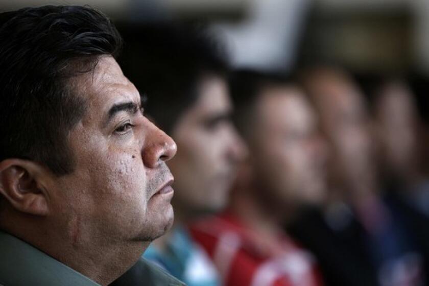Javier Ortiz, a former Michoacan state police officer, appears at a news conference in Mexico City with nine other people suspected of having ties to a drug cartel. A top advisor to the states governor was among those detained.