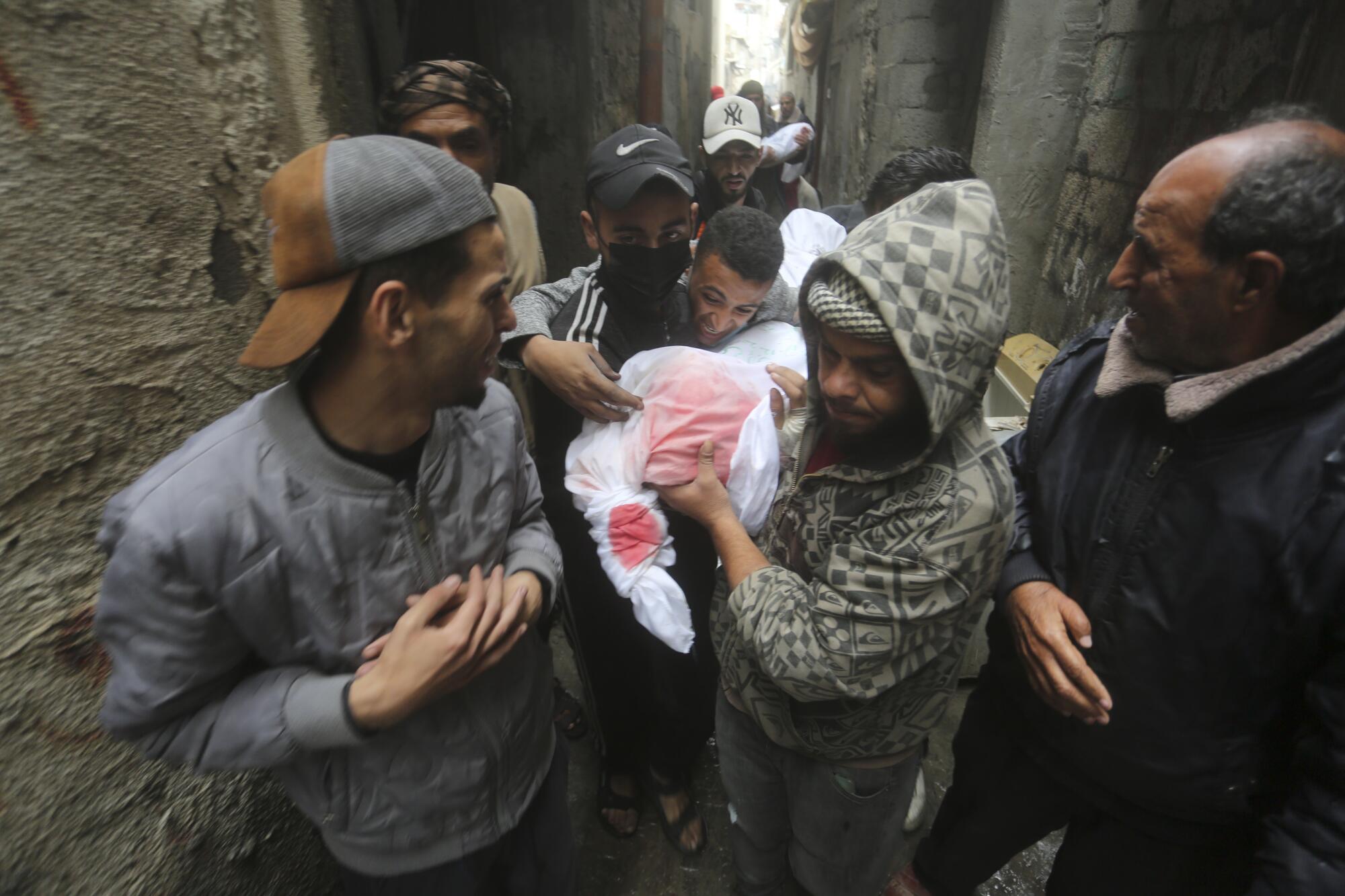 Gazans carrying people killed in the Israeli bombardment