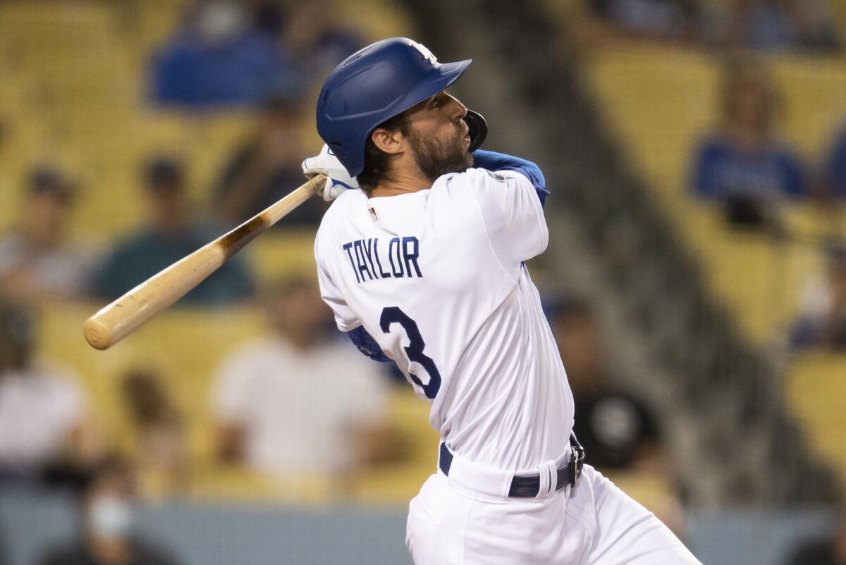 Los Angeles Dodgers' Chris Taylor watches his solo home run during the fifth inning.