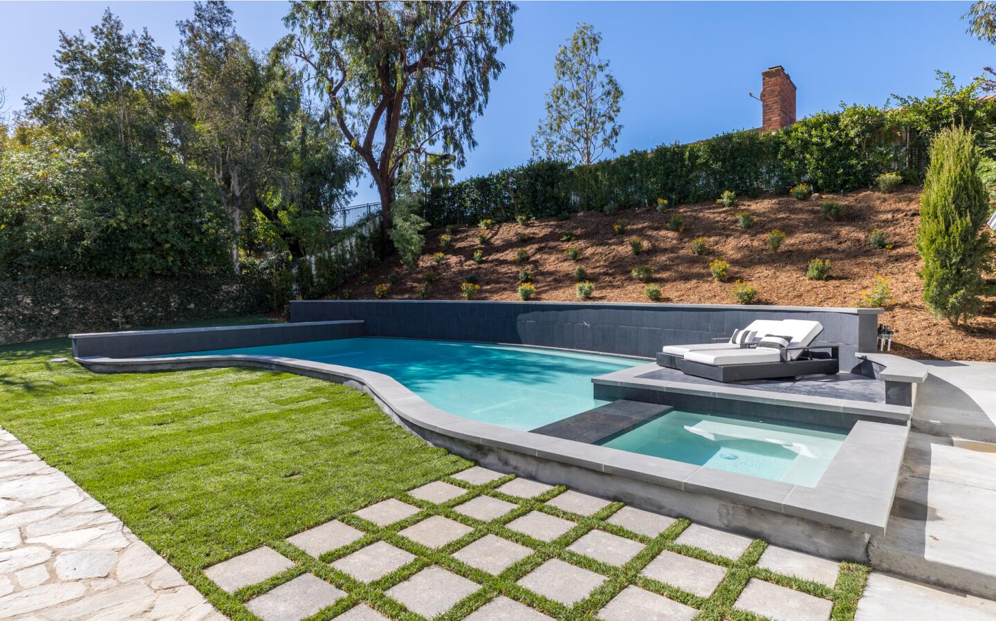 A backyard pool and spa.