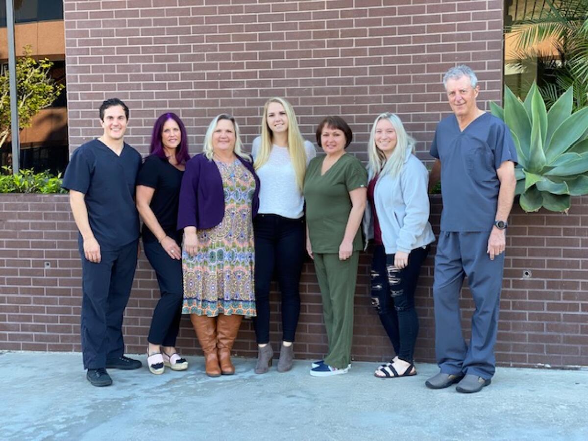 Drs. Kevin Stewart (left) and Jeff Javelet (right) gather with the team at La Jolla Village Endodontics.