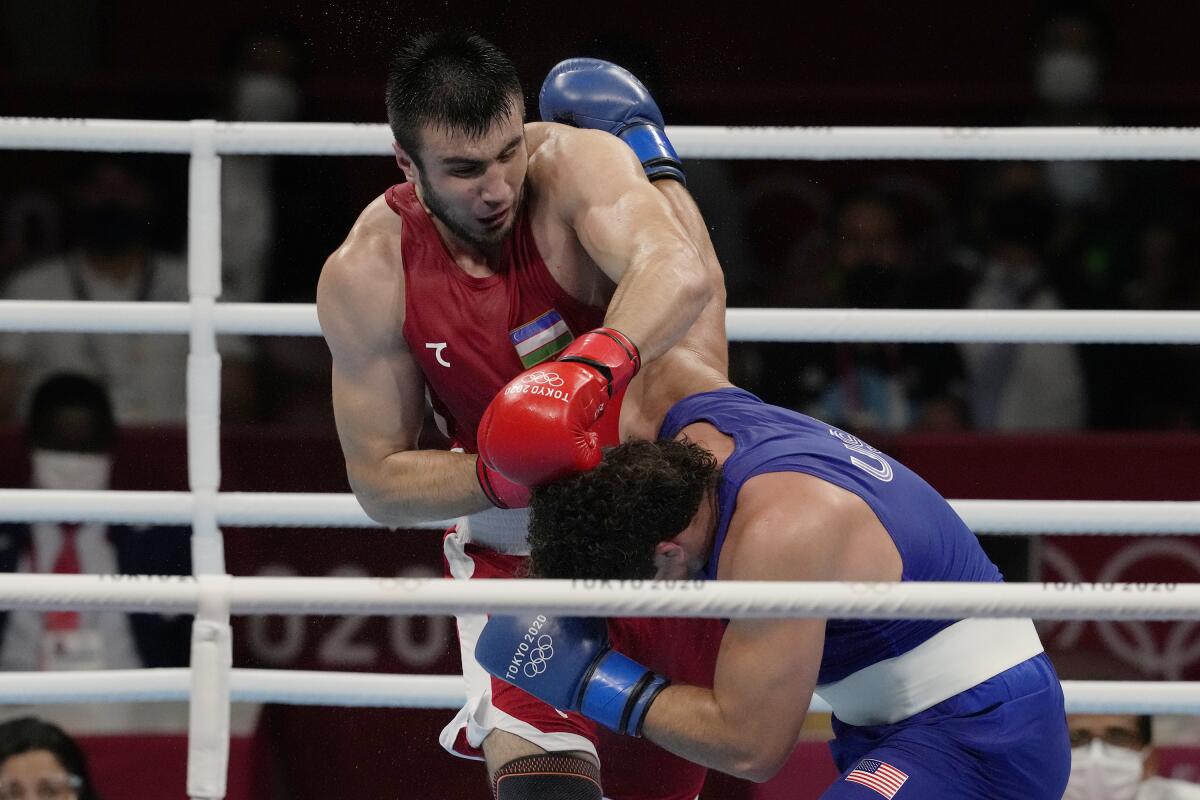 Uzbekistan's Bakhodir Jalalov, top, exchanges punches with Richard Torrez Jr., from the United States during their men's super heavyweight over 91-kg boxing gold medal match at the 2020 Summer Olympics, Sunday, Aug. 8, 2021, in Tokyo, Japan. (AP Photo/Themba Hadebe)