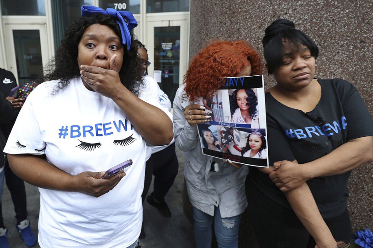 Photos of Breonna Taylor are displayed during a vigil for her in Louisville, Ky., on March 19.