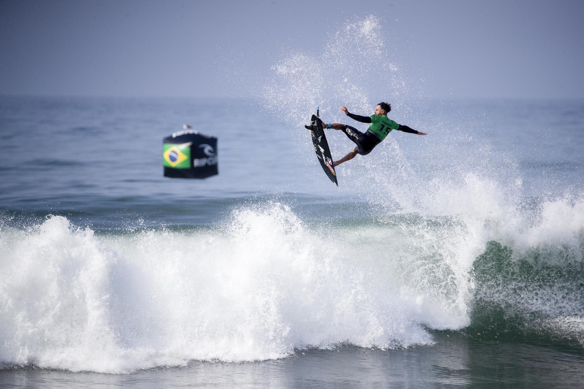 Italo Ferreira of Brazil gets some big air during his first match at the WSL Finals.