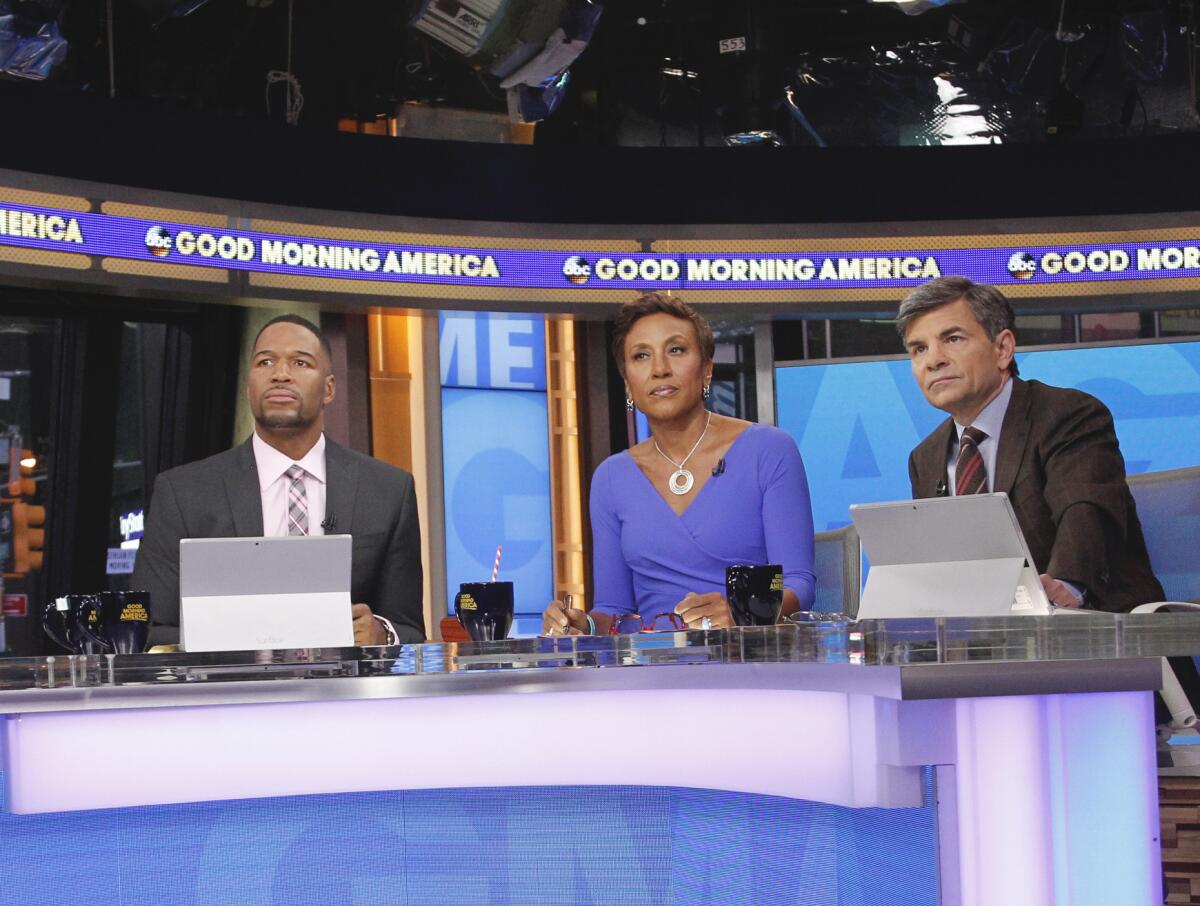 Michael Strahan, Robin Roberts and George Stephanopoulos on the set of ABC's "Good Morning America."