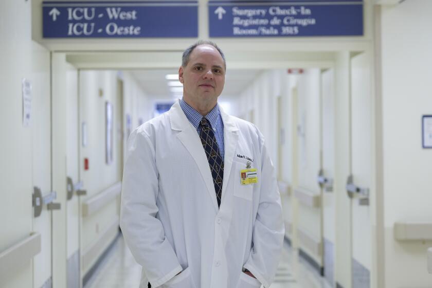 CHICAGO, ILLINOIS MARCH 1, 2019 ? Adam Litwin poses for a portrait in front of the ICU unit at the John H. Stroger, Jr. Hospital of Cook County Friday, March 1, 2019. Litwin, who was arrested in 2000 after posing as a doctor for over 6 months at UCLA, promised his grandfather on his deathbed that he would finish medical school. Explaining his misdemeanor nearly two decades ago, Litwin said he was blinded by his passion for medicine. He recently graduated from Saint James School of Medicine Anguilla and currently conducts clinical research in anesthesiology at John H. Stroger, Jr. Hospital of Cook County, while awaiting placement in a residency program. (Pinar Istek / For The Times)