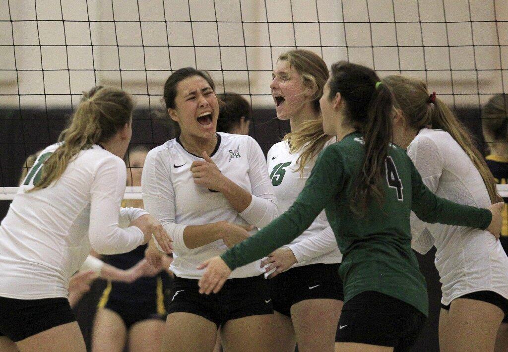 Sage Hill School's Kekai Whitford, second from left, celebrates a point with teammates, Claudia Noto, far left, Maddy Abbott (15), Allie Mowrey (4) and Halland McKenna, far right, during the second set against Crean Lutheran in a CIF State Southern California Regional Division III semifinal match.