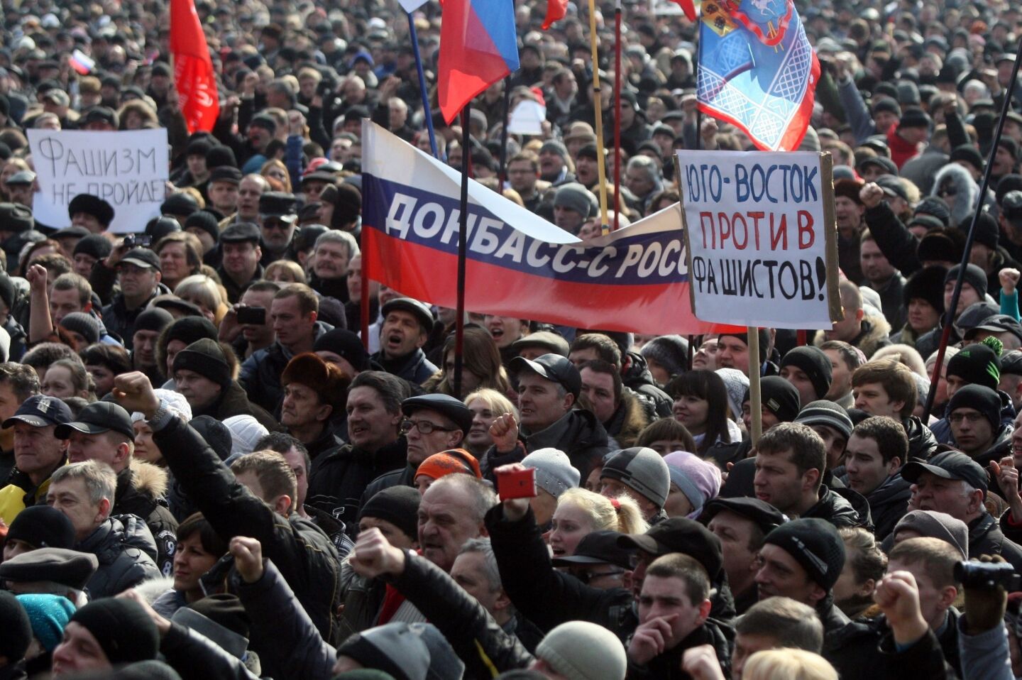 Protesters hold a banner reading "Donetsk region with Russia" and a placard reading "South-east against fascism!" during a rally in the industrial Ukrainian city of Donetsk.