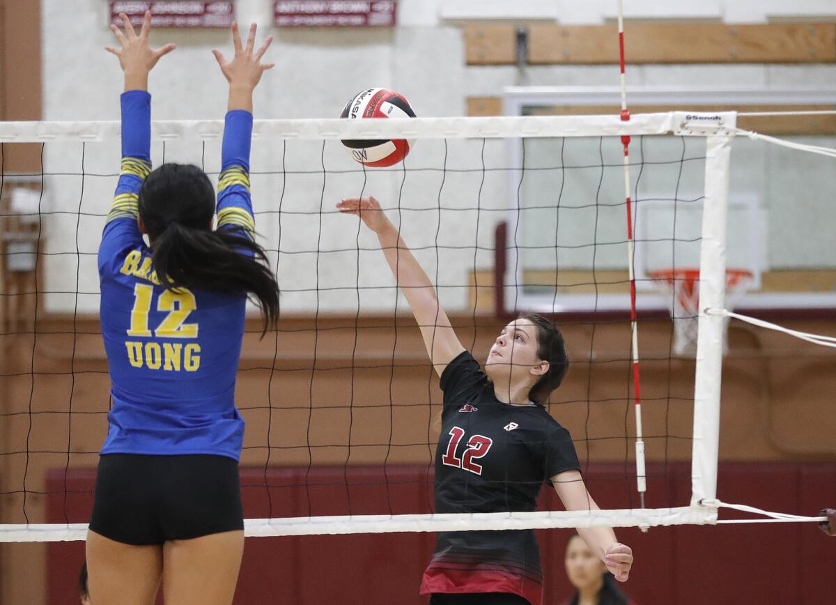 Ocean View's Mikayla Fields (12) sends a ball over a Fountain Valley blocker on Monday.