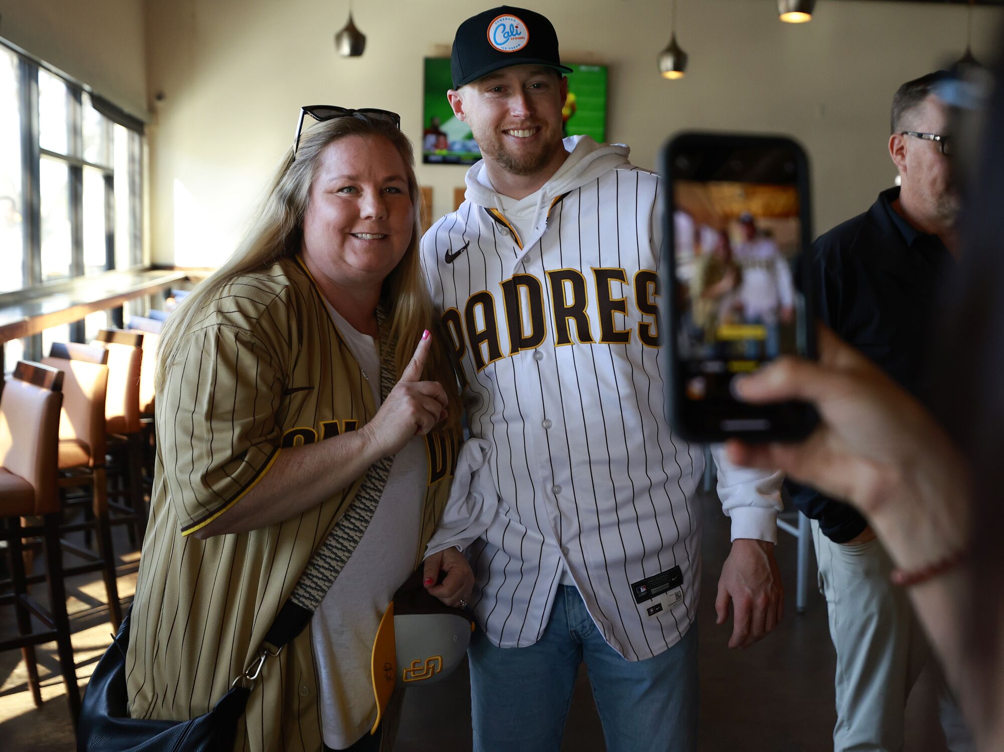 Padres Jake Cronenworth takes a photo with fan Tina Heap at Ballast Point Brewing in Little Italy.