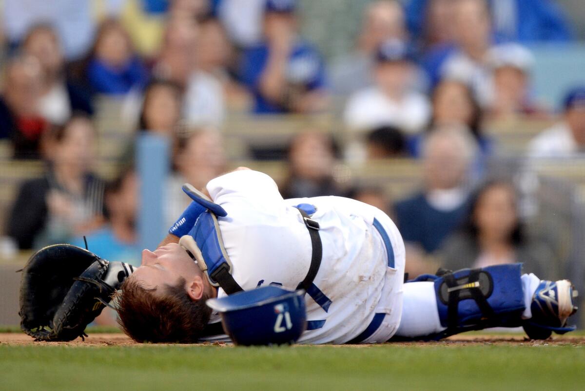 Dodgers catcher A.J. Ellis recovers from a collision at the plate with St. Louis Cardinals' Jon Jay.