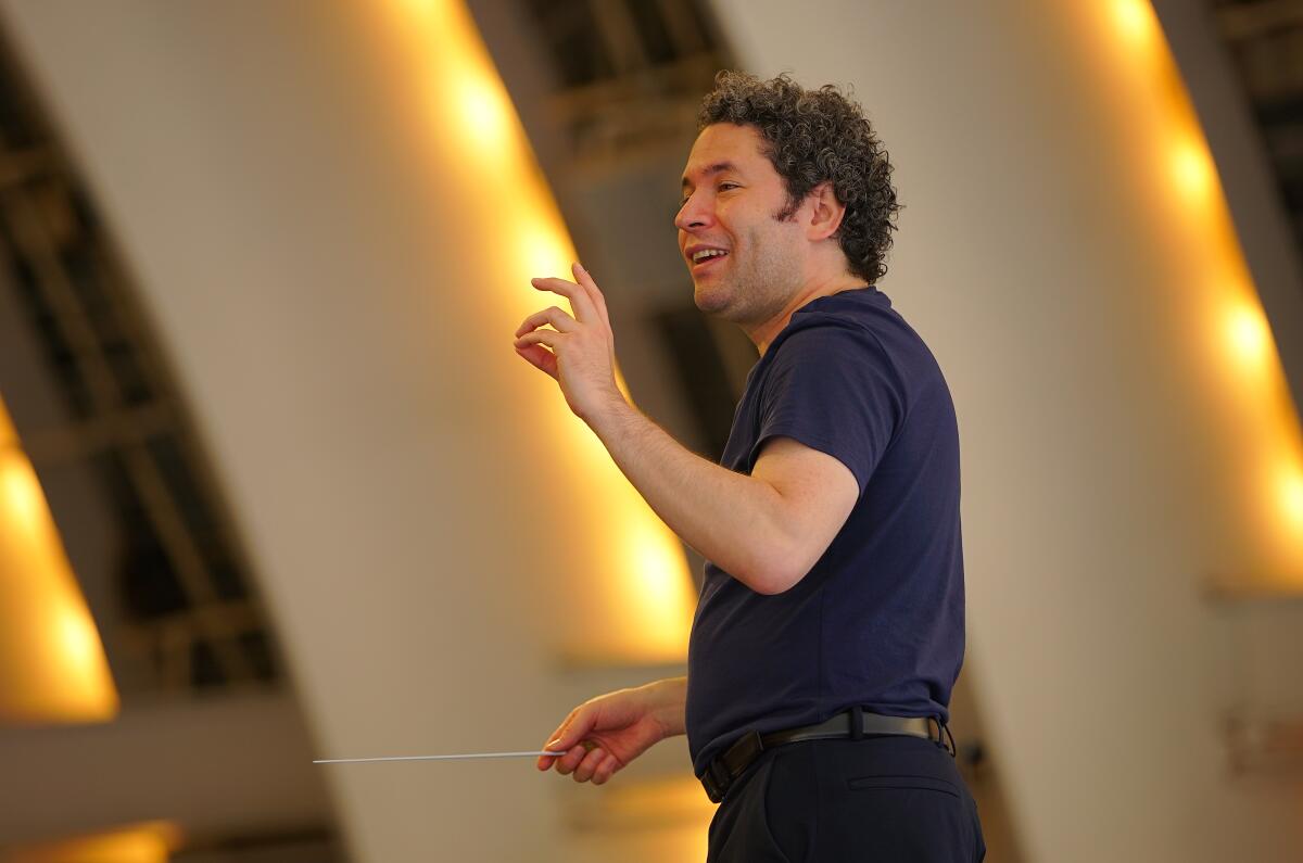 Gustavo Dudamel gestures as he talks to the orchestra.