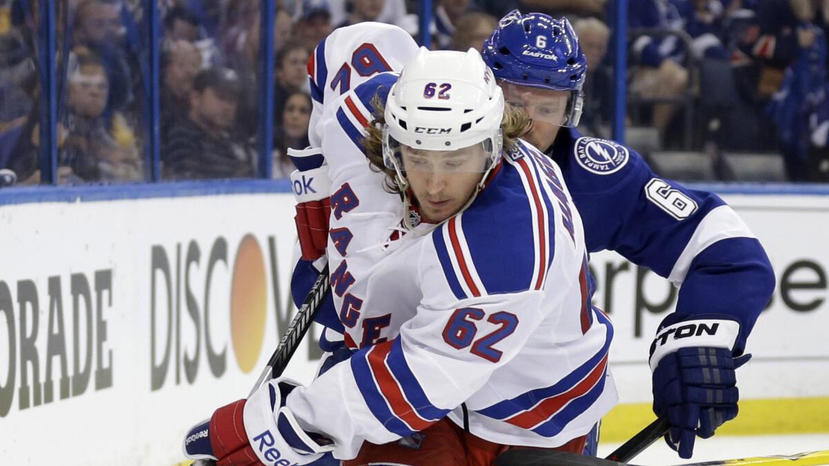 New York Rangers forward Carl Hagelin controls the puck in front of Tampa Bay Lightning defenseman Anton Stralman during Game 4 of the Eastern Conference finals on May 22. Hagelin was acquired by the Ducks on Saturday.