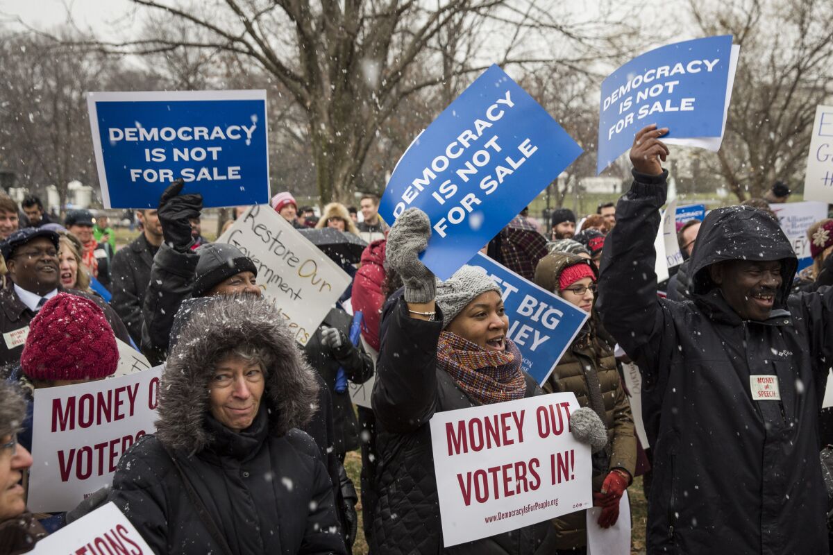 Attendees of a rally in Washington last January call for an end to corporate money in politics as part of a protest marking the fifth anniversary of the Supreme Court's Citizens United decision.