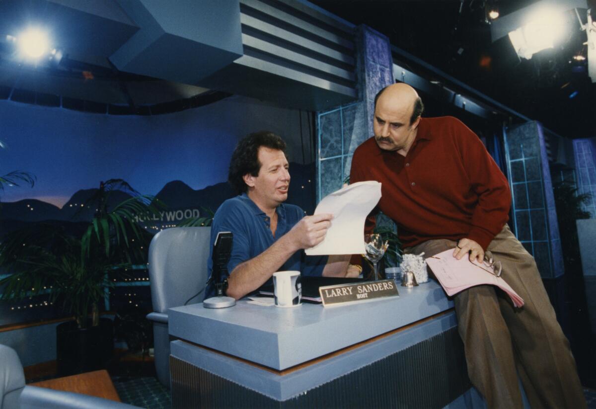 Garry Shandling, left, and Jeffrey Tambor work on the set of "The Larry Sanders Show" in 1992.