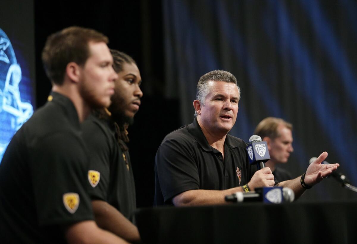 Arizona State Coach Todd Graham, right, speaks next to quarterback Taylor Kelly, left, and Will Sutton during the Pac-12 football media day in July. Graham has brought order to the Sun Devils' program.