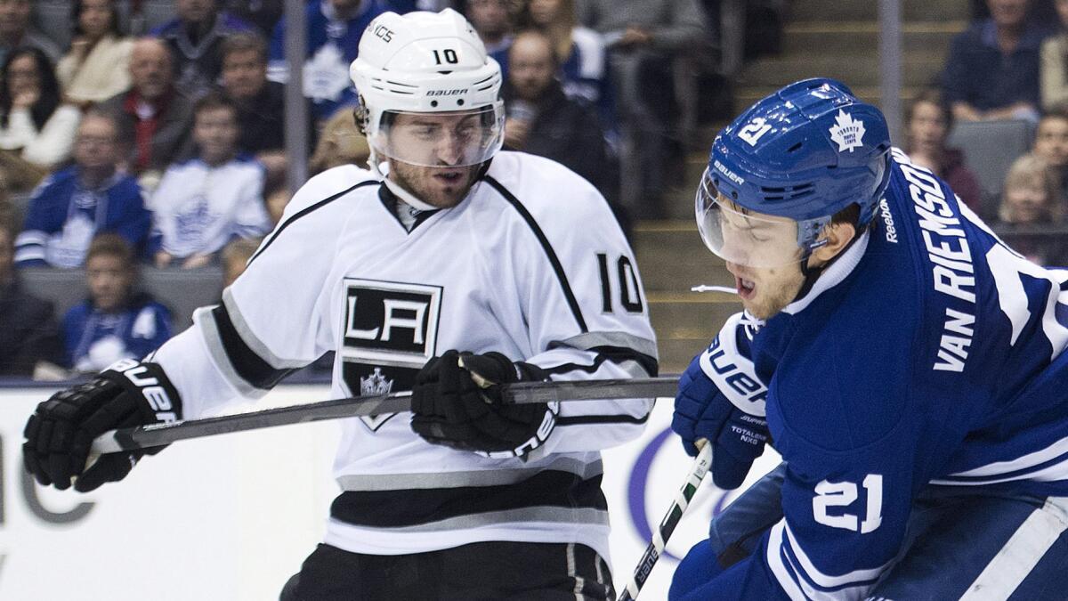 Kings forward Mike Richards, left, and Toronto Maple Leafs forward James van Riemsdyk battle in front of the net during a game on Dec. 14.