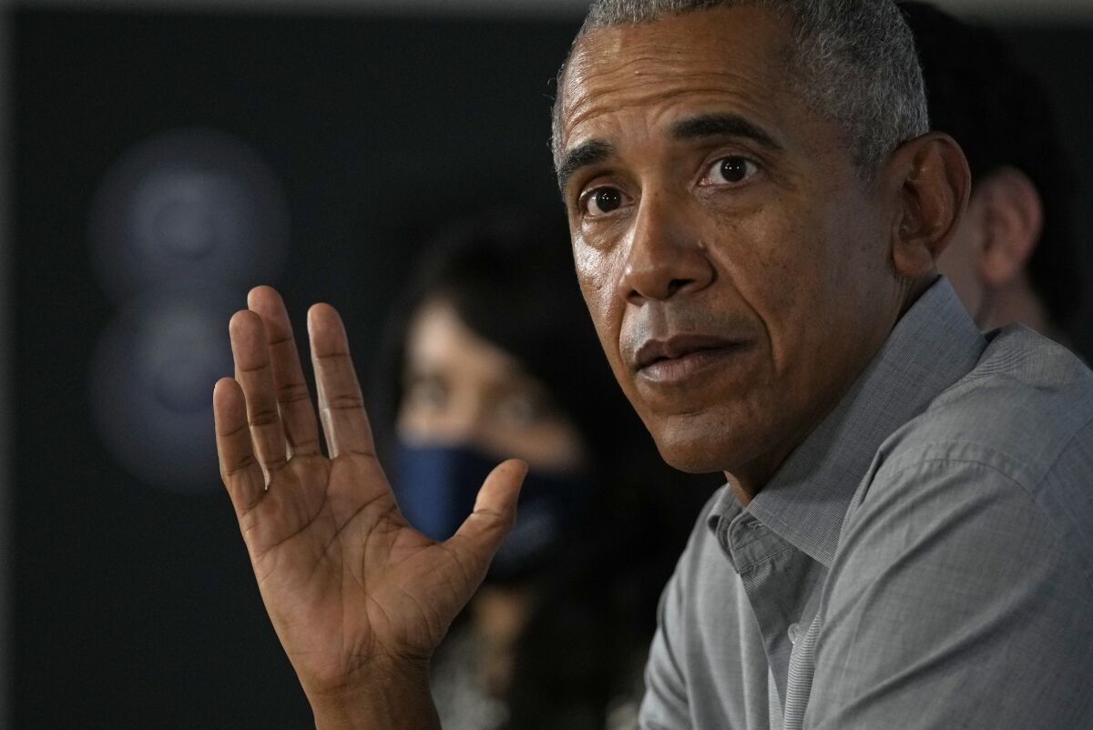 Former U.S. President Barack Obama gestures as he attends a roundtable meeting at the COP26 U.N. Climate Summit in Glasgow, Scotland, Monday, Nov. 8, 2021. The U.N. climate summit in Glasgow gathers leaders from around the world, in Scotland's biggest city, to lay out their vision for addressing the common challenge of global warming. (AP Photo/Alastair Grant)