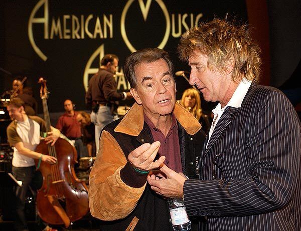 Producer Dick Clark and Rod Stewart talk during rehearsals for the 2003 American Music Awards in Los Angeles.
