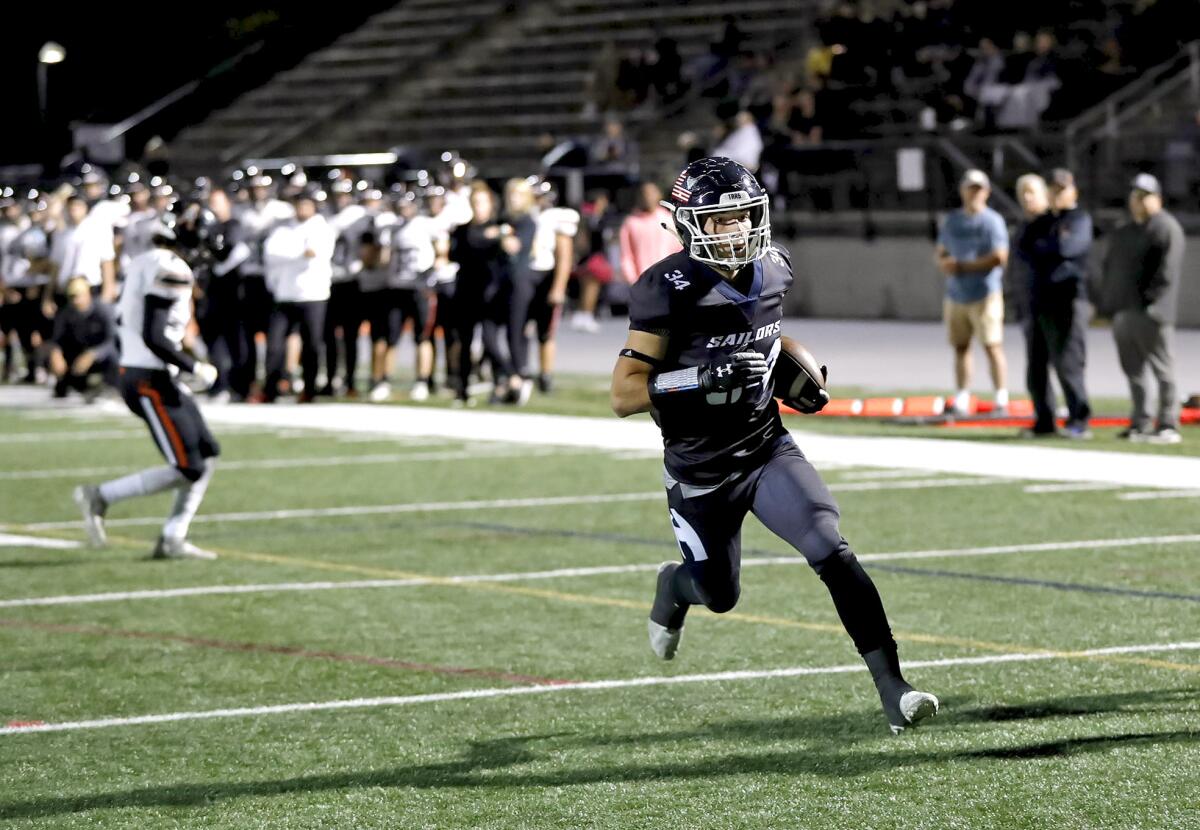 Newport Harbor's Payton Irving steps into the end zone for a touchdown in the first half on Friday.