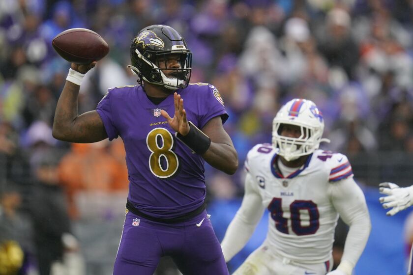 Baltimore Ravens quarterback Lamar Jackson (8) passes as he is pressured by Buffalo Bills linebacker Von Miller (40) in the first half of an NFL football game Sunday, Oct. 2, 2022, in Baltimore. (AP Photo/Julio Cortez)