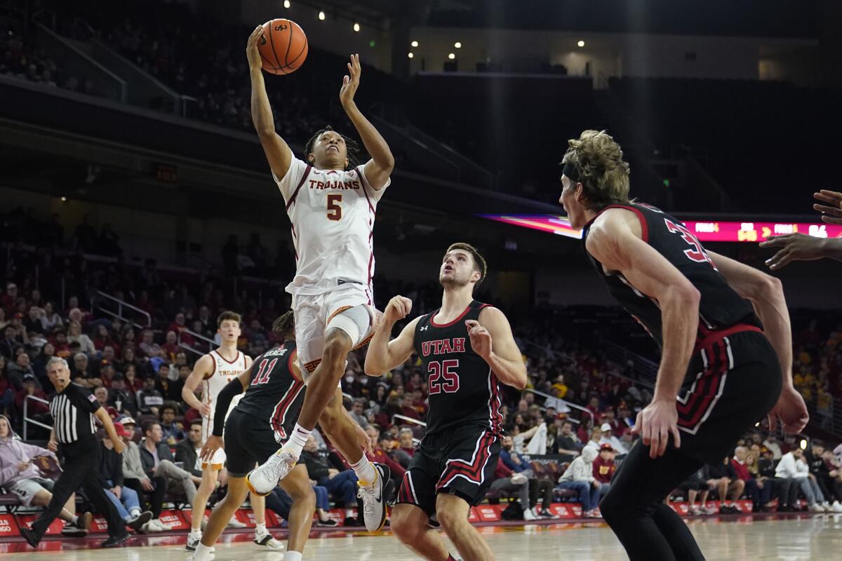 USC guard Boogie Ellis drives past Utah guard Rollie Worster (25) during the second half Jan. 14, 2023.
