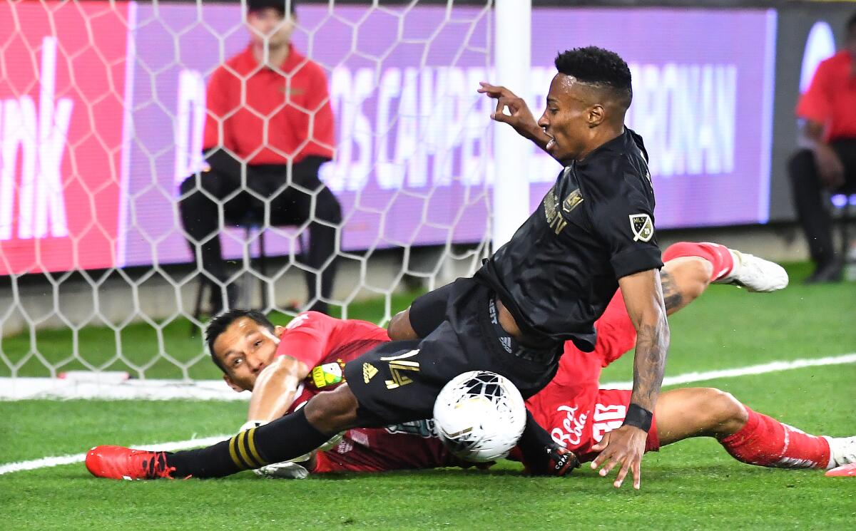 LAFC's Mark-Anthony Kaye tries to score on Leon's goalie Rodoolfo Cota in the first half during the CONCACAF Champions League match at Banc of California on Thursday.