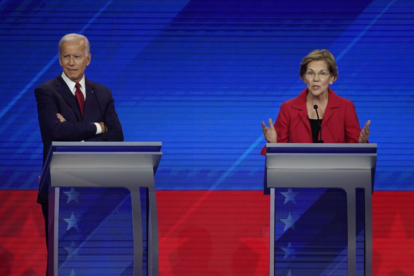 Joe Biden listens as Elizabeth Warren speaks.
