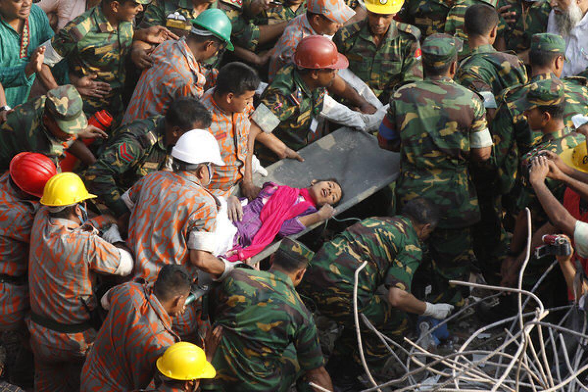 Bangladeshi rescuers retrieve garment worker Reshma from the rubble of a building in Savar on Friday,, 17 days after the eight-story building collapsed.