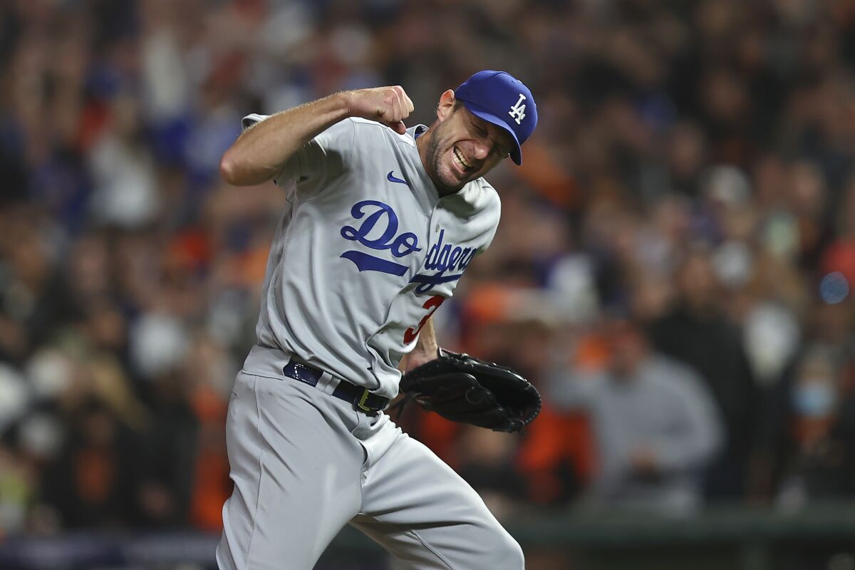 Los Angeles Dodgers pitcher Max Scherzer celebrates after the Dodgers defeated the San Francisco Giants in Game 5 of a baseball National League Division Series Thursday, Oct. 14, 2021, in San Francisco. (AP Photo/John Hefti)