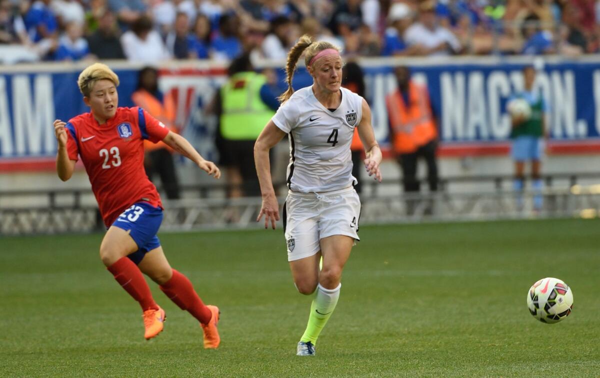 Becky Sauerbrunn, right, tries to get away from South Korea's Lee Sodam during a friendly match May 30 in Harrison, New Jersey.