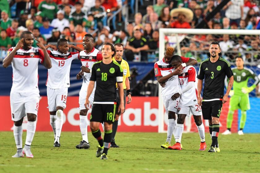 Trinidad and Tobago's Keron Cummings (3rd R) and Joevin Jones celebrate Cummings' goal against Mexico during a CONCACAF Gold Cup Group C match in Charlotte, North Carolina, on July 15, 2015. AFP PHOTO/NICHOLAS KAMMNICHOLAS KAMM/AFP/Getty Images ** OUTS - ELSENT, FPG - OUTS * NM, PH, VA if sourced by CT, LA or MoD **