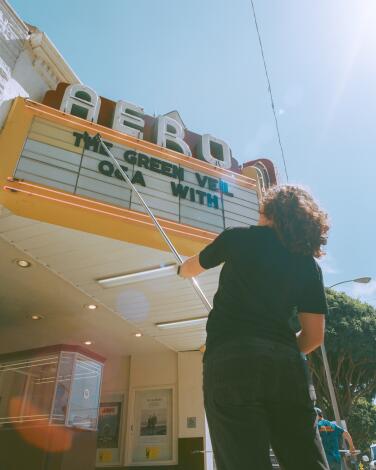 Person changing the marquee at the Aero Theatre