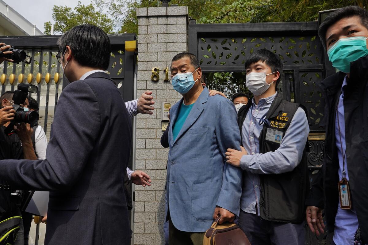 Hong Kong media tycoon Jimmy Lai, center, was one of at least 14 pro-democracy lawmakers and activists arrested in Hong Kong on Saturday on charges of joining unlawful protests last year.