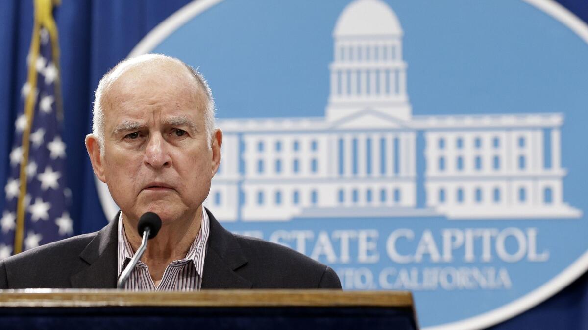Gov. Jerry Brown listens to questions about his revised 2018-19 state budget at a Capitol news conference May 11.