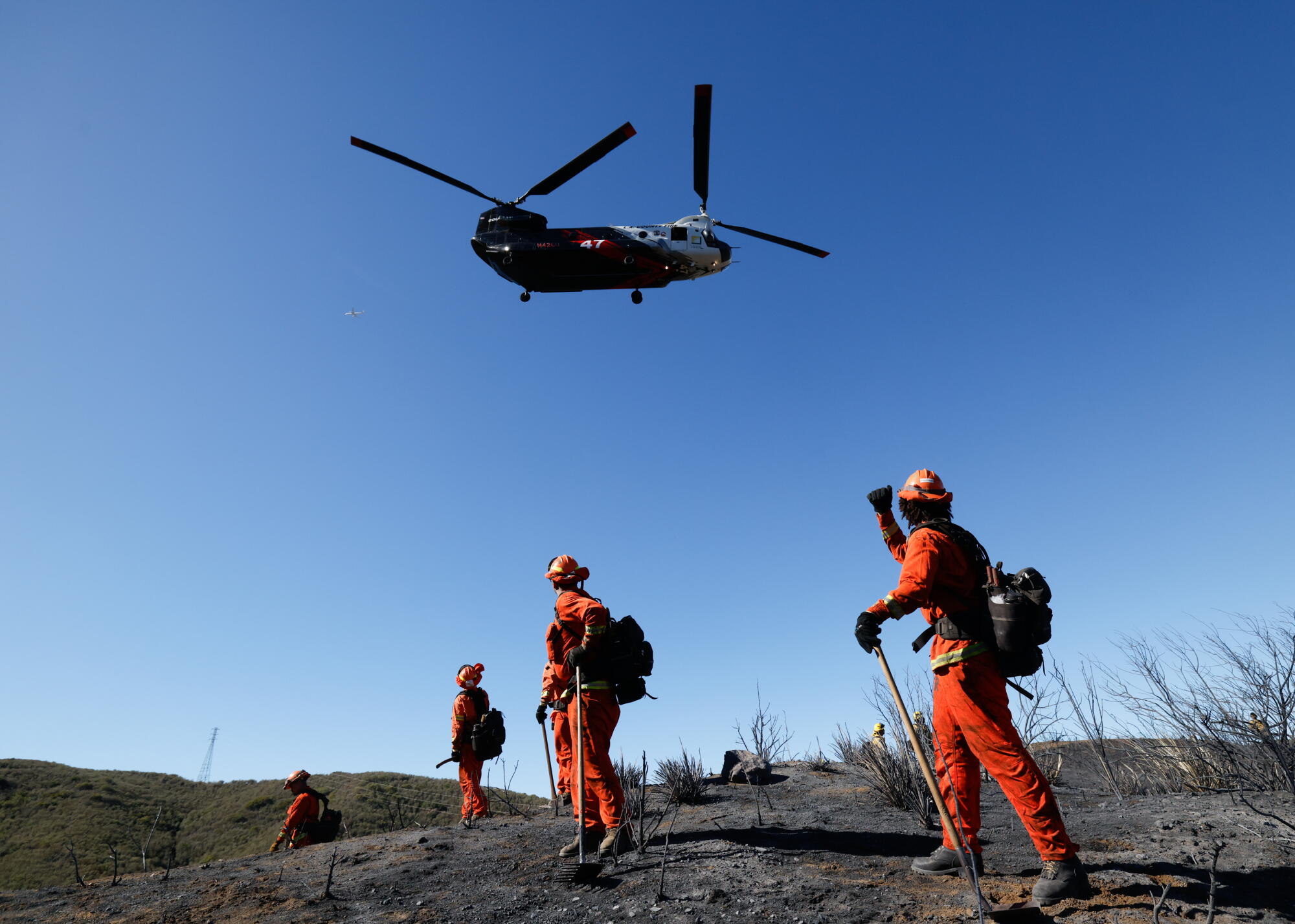 A heli-tanker flies complete while conducting h2o drops.