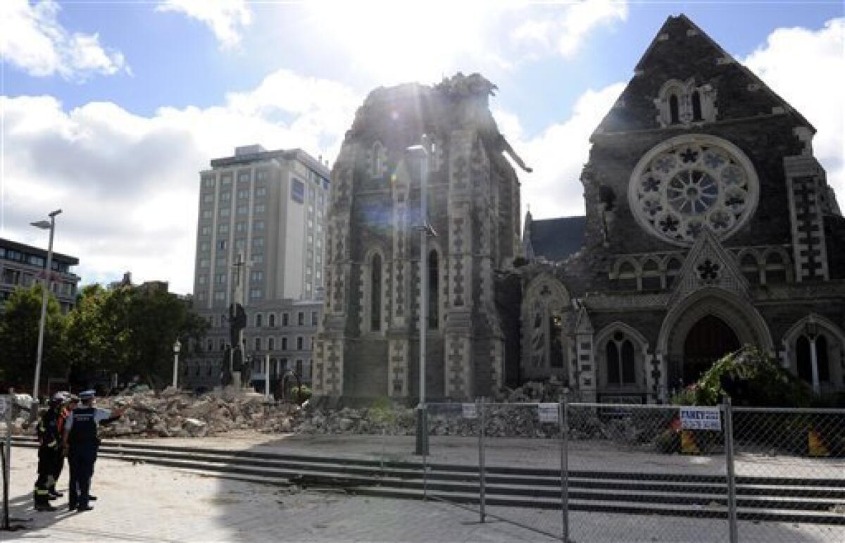 Police and search and recovery team members assess damage of the Christchurch Cathedral in Christchurch, New Zealand, Thursday, Feb. 24, 2011 after the city was hit by a 6.3 magnitude earthquake Tuesday, Feb 22. (AP Photo/Rob Griffith)