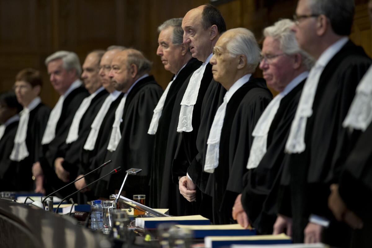 Presiding judge Peter Tomka of Slovakia, fourth from right, opens an International Court of Justice session in The Hague, Netherlands, on Feb. 3.