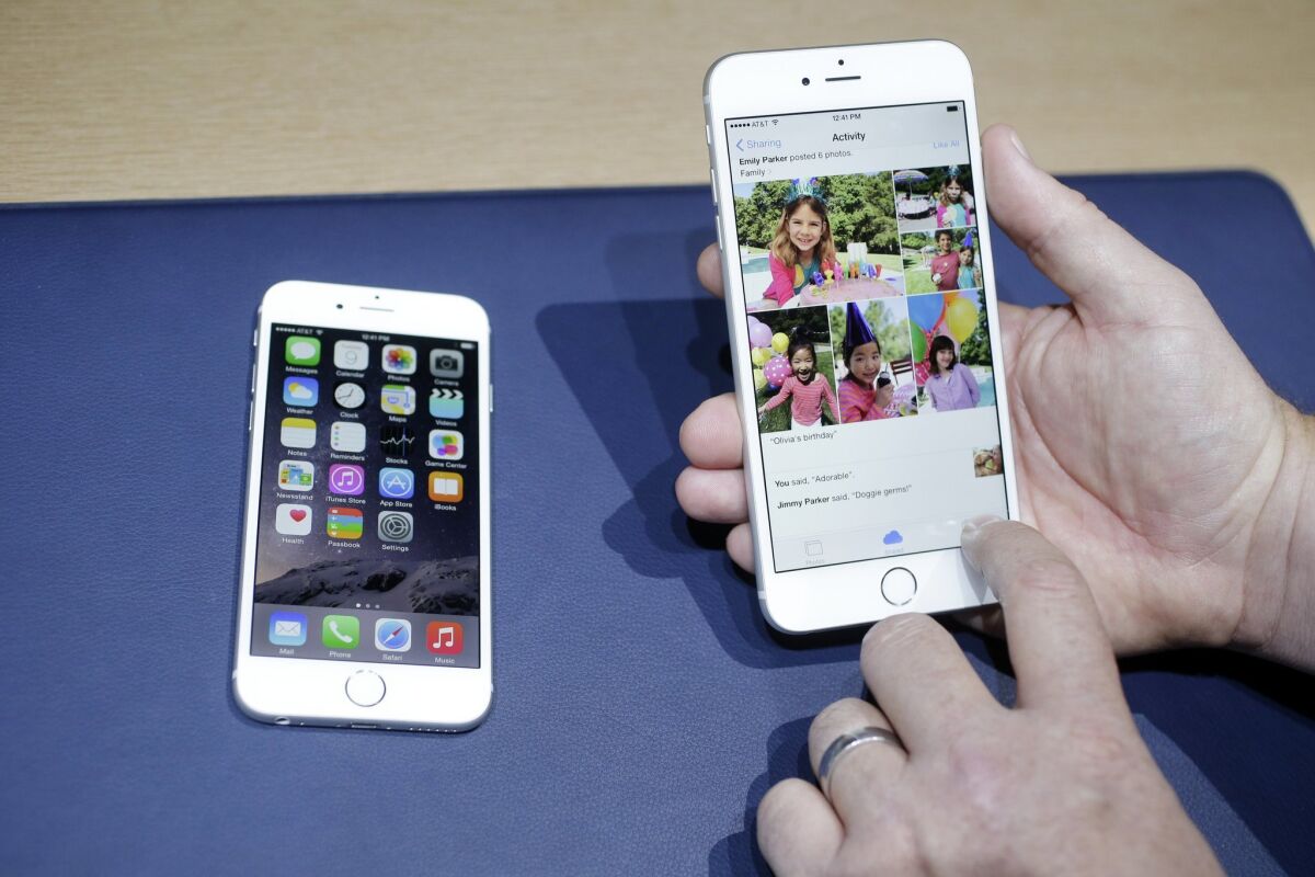 In this file photo, the iPhone 6, at left, and iPhone 6 plus are shown next to each other during a new product release in Cupertino, Calif.