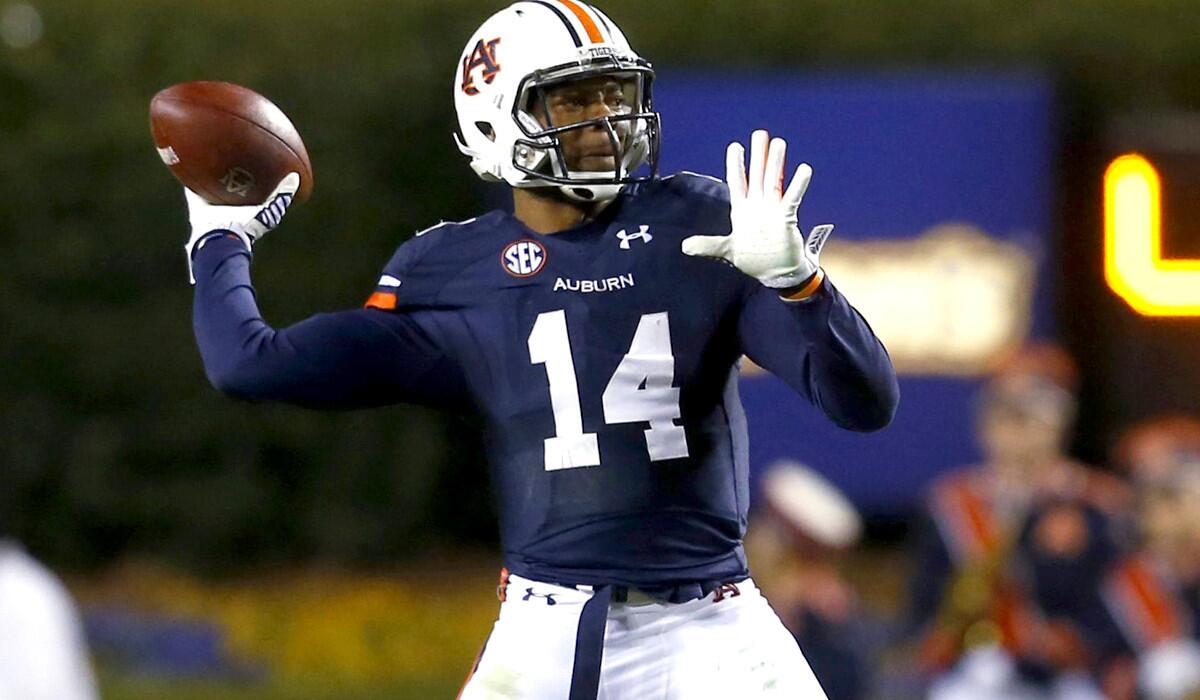 Quarterback Nick Marshall (14) and Auburn spoiled Alabama's march toward a national title last season and played their way into the BCS title game. A Tigers victory this season could keep both teams out of the College Football Playoff.