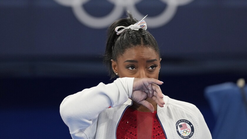 Simone Biles looks on during the women's gymnastics team final at the Tokyo Olympics on Tuesday.