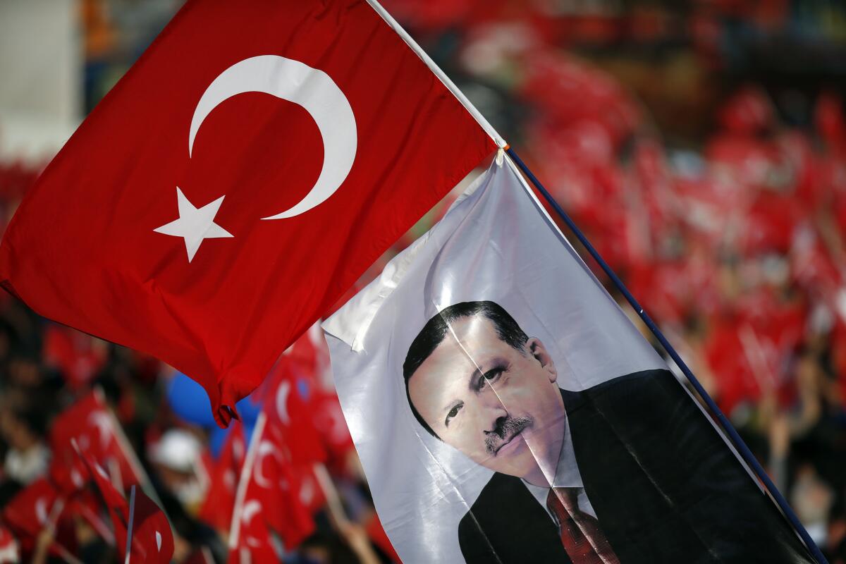 A flag with an image of Turkey's President Recep Tayyip Erdogan waves during celebrations of the 563rd anniversary of the Ottoman conquest of Constantinople, now Istanbul, in Turkey's capital on Sunday.