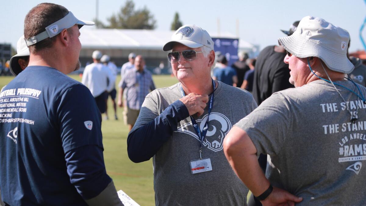 Defensive coordinator Wade Phillips, center, talks to fellow coaches at Rams training camp last August. Phillips, 72, appears trimmed down this year.